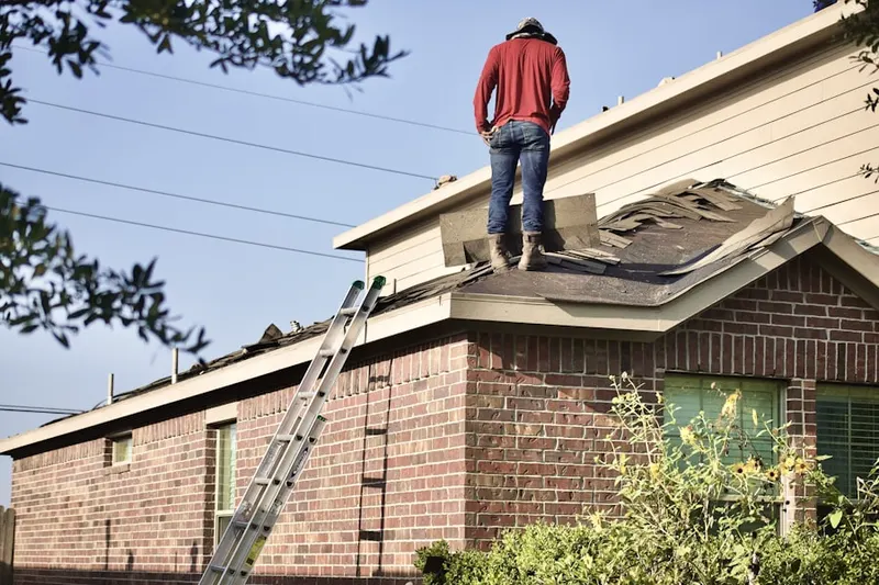 Professional roofer working on a residential roof in Heritage Village